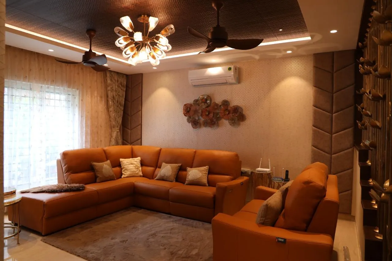 RICCO completed living room with custom seating, decorative lighting and layered ceiling details