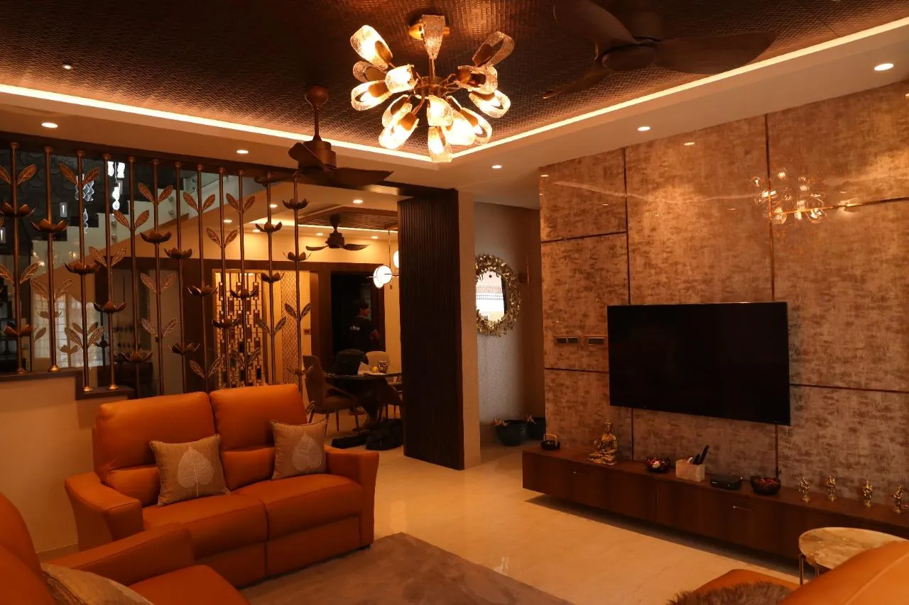 Completed RICCO living room with layered lighting, custom divider and media wall